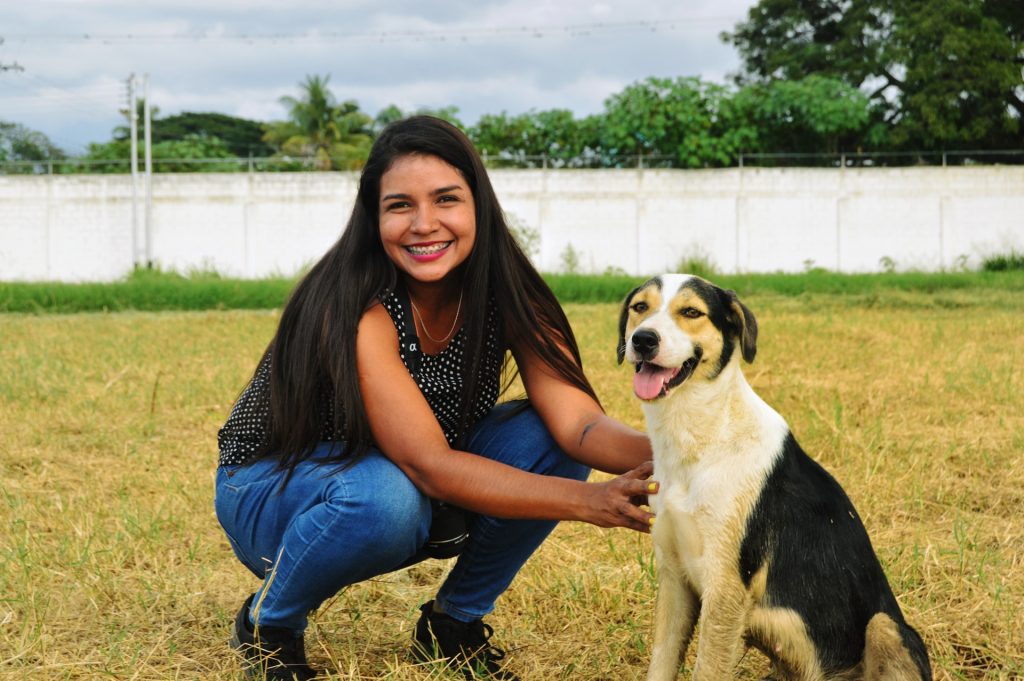 Woman beside dog.