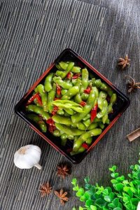 Edamame in black bowl.