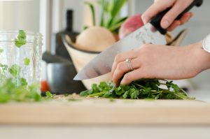 Person chopping cilantro.